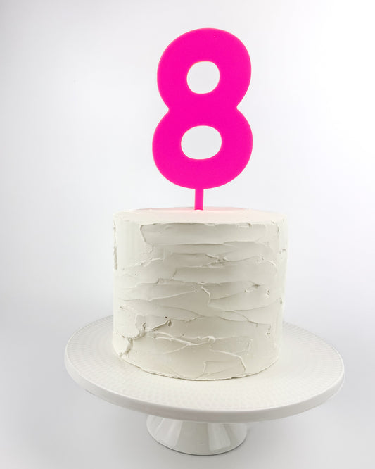 Cake with a hot pink number 8 cake topper 