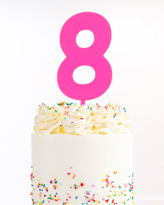 Cake with a hot pink number 8 cake topper 